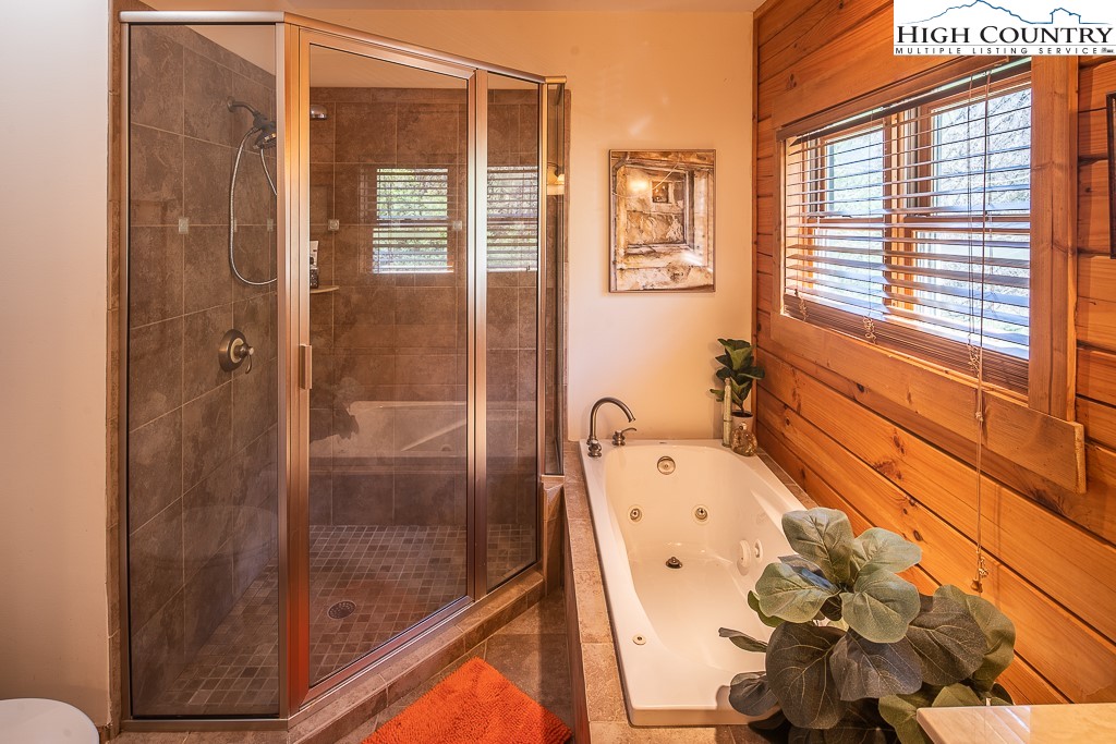 154 Lilac Lane Boone, NC 28607 - Photo 26 of 50 a bathroom with a bathtub and a shower