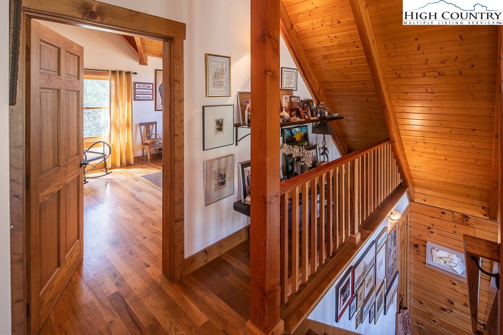 154 Lilac Lane Boone, NC 28607 - Photo 31 of 50 a view of a hallway with wooden floor and staircase
