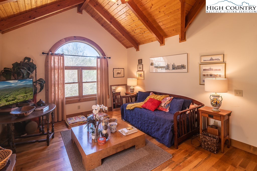 154 Lilac Lane Boone, NC 28607 - Photo 33 of 50 a living room with furniture a wooden floor and a flat screen tv