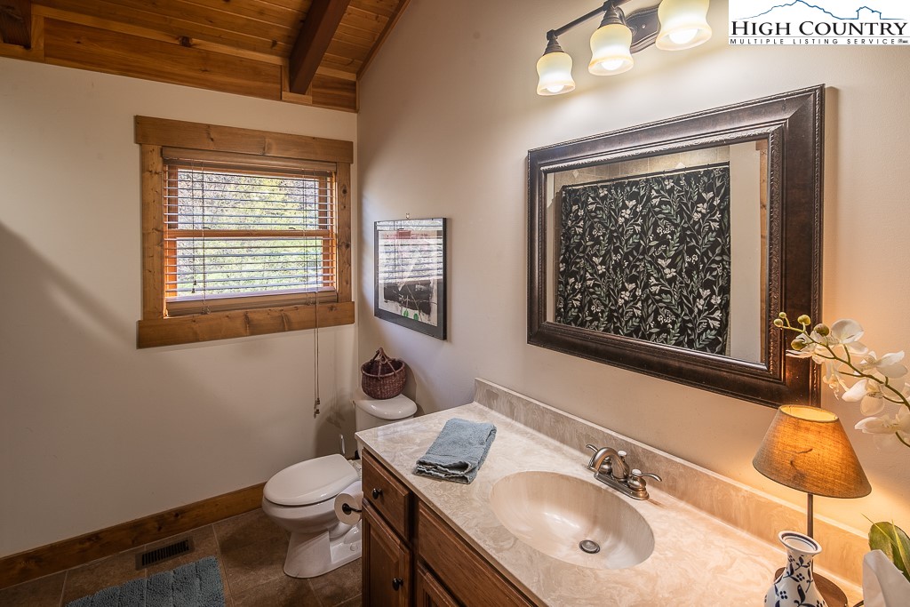 154 Lilac Lane Boone, NC 28607 - Photo 35 of 50 a bathroom with a sink vanity mirror and toilet