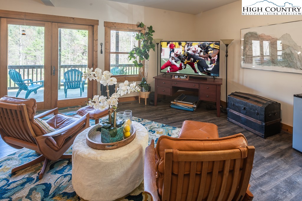 154 Lilac Lane Boone, NC 28607 - Photo 37 of 50 a living room with furniture a flat screen tv and a fireplace