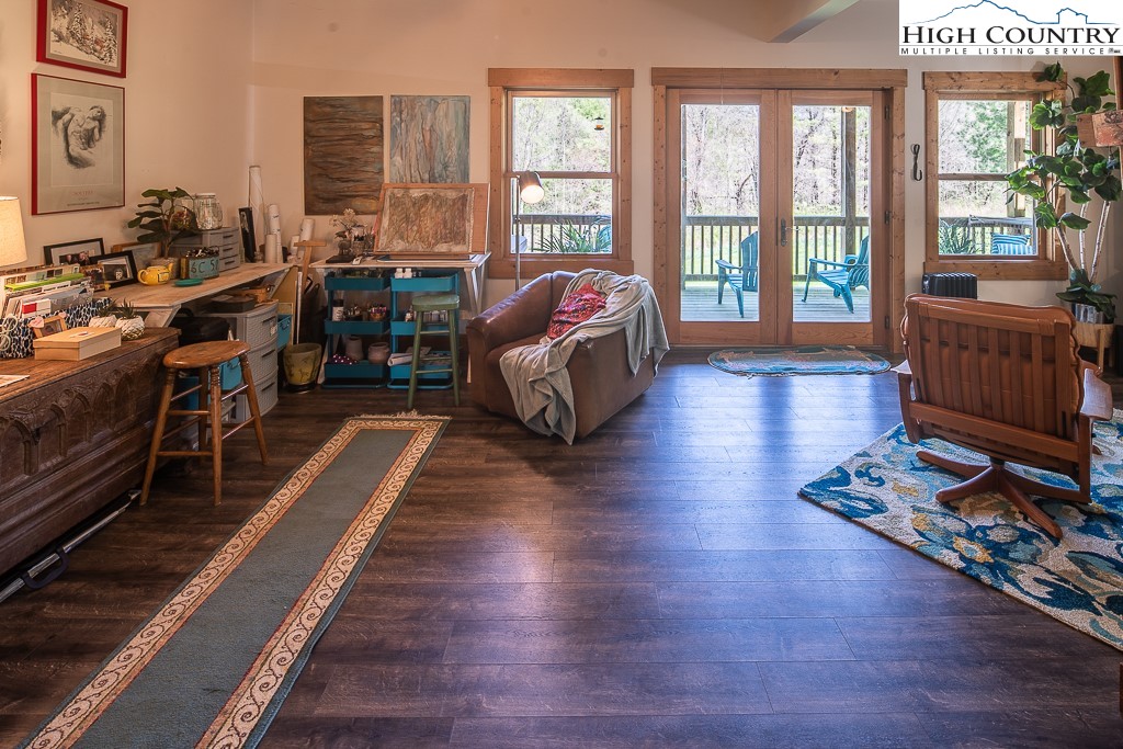 154 Lilac Lane Boone, NC 28607 - Photo 40 of 50 a living room with furniture and a floor to ceiling window