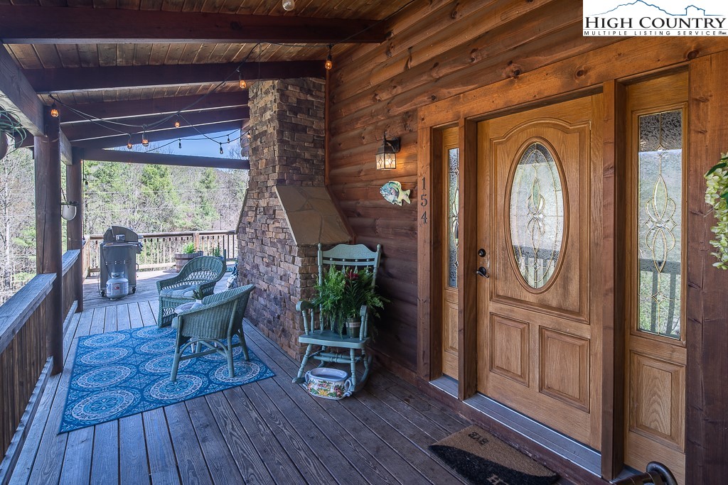 154 Lilac Lane Boone, NC 28607 - Photo 5 of 50 a view of living room filled with furniture and wooden floor