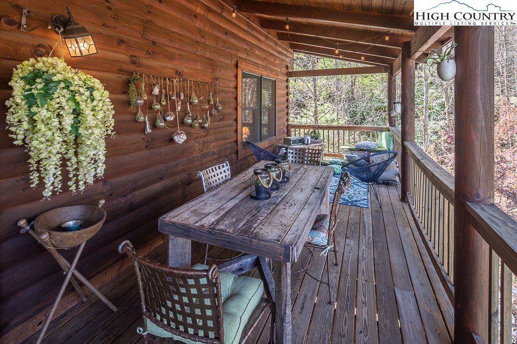 154 Lilac Lane Boone, NC 28607 - Photo 6 of 50 a view of a balcony with furniture and wooden floor