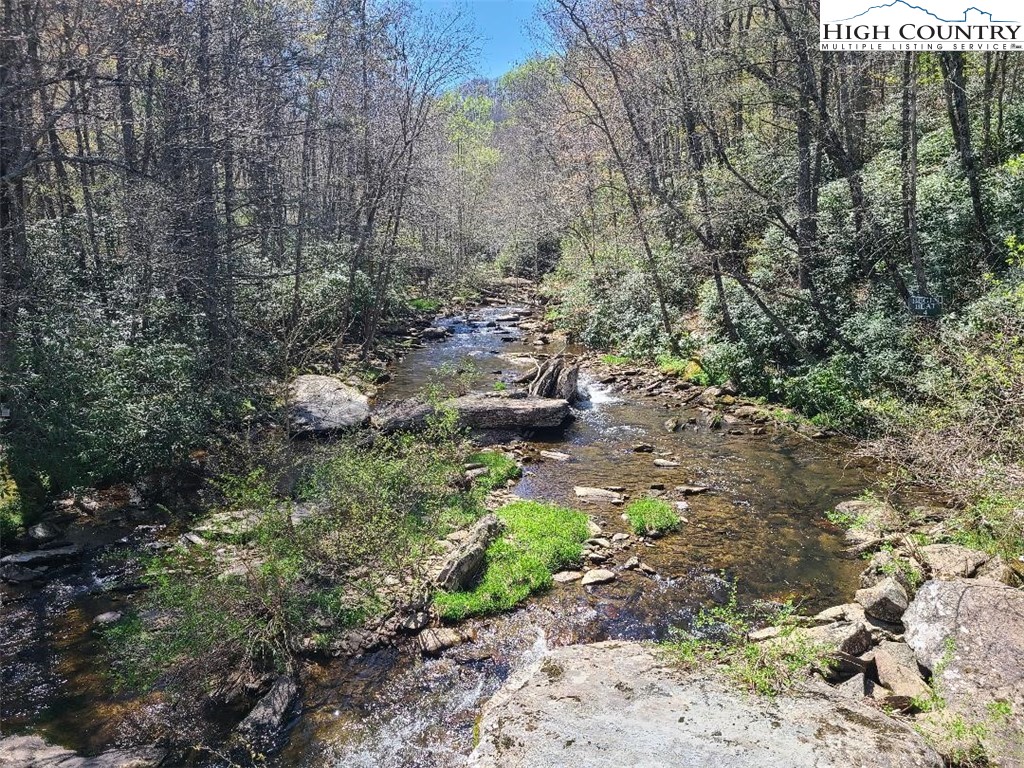 154 Lilac Lane Boone, NC 28607 - Photo 7 of 50 a backyard of a house with a yard and outdoor seating