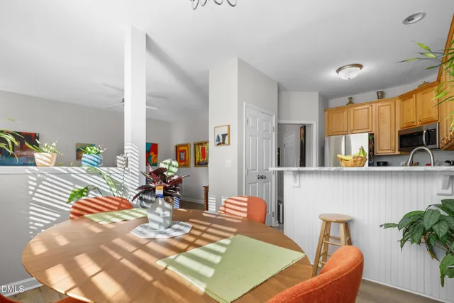 a view of a dining room with furniture and a potted plant