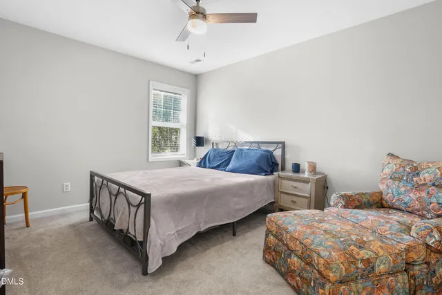a bedroom with two beds and window