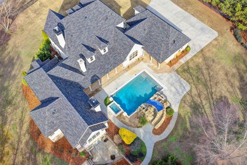 4045 Ridge Road Buford, GA 30519 - Photo 91 of 97 an aerial view of a house with garden space and parking