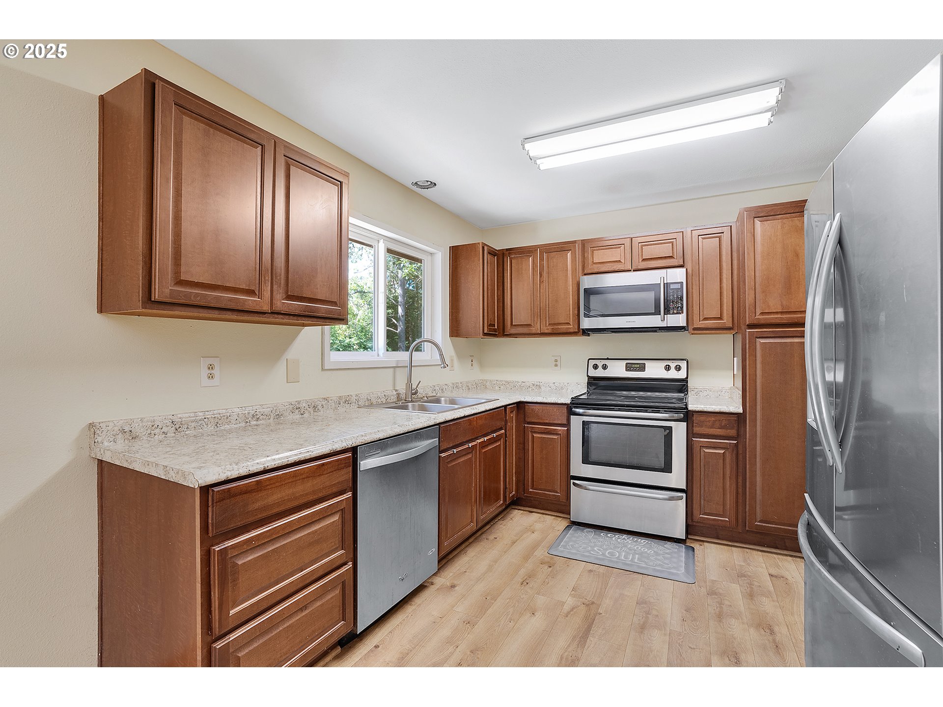 701 Northeast Evans Road Corbett, OR 97019 - Photo 17 of 48 a kitchen with a refrigerator stove top oven and sink