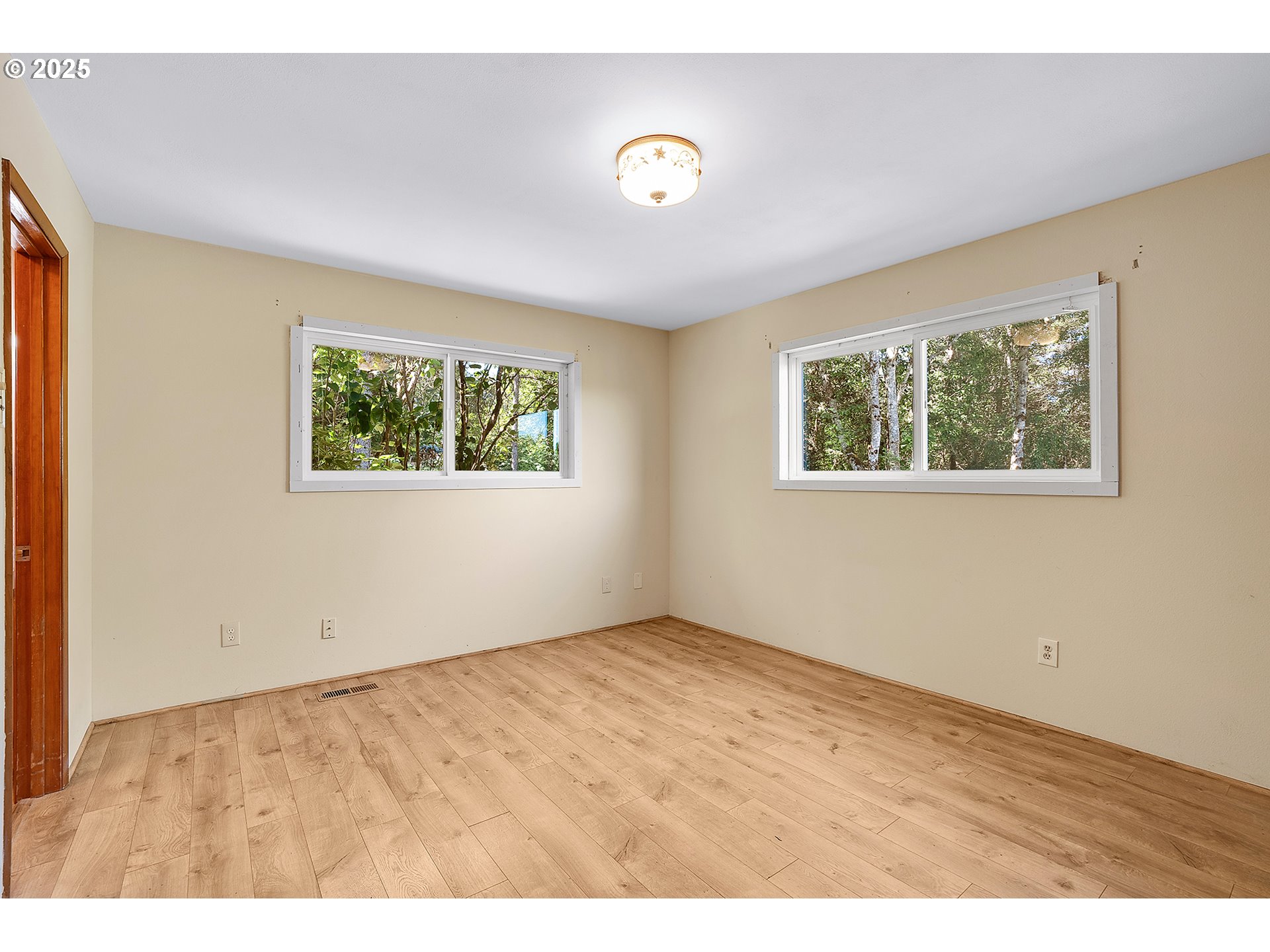 701 Northeast Evans Road Corbett, OR 97019 - Photo 22 of 48 a view of an empty room with wooden floor and a window