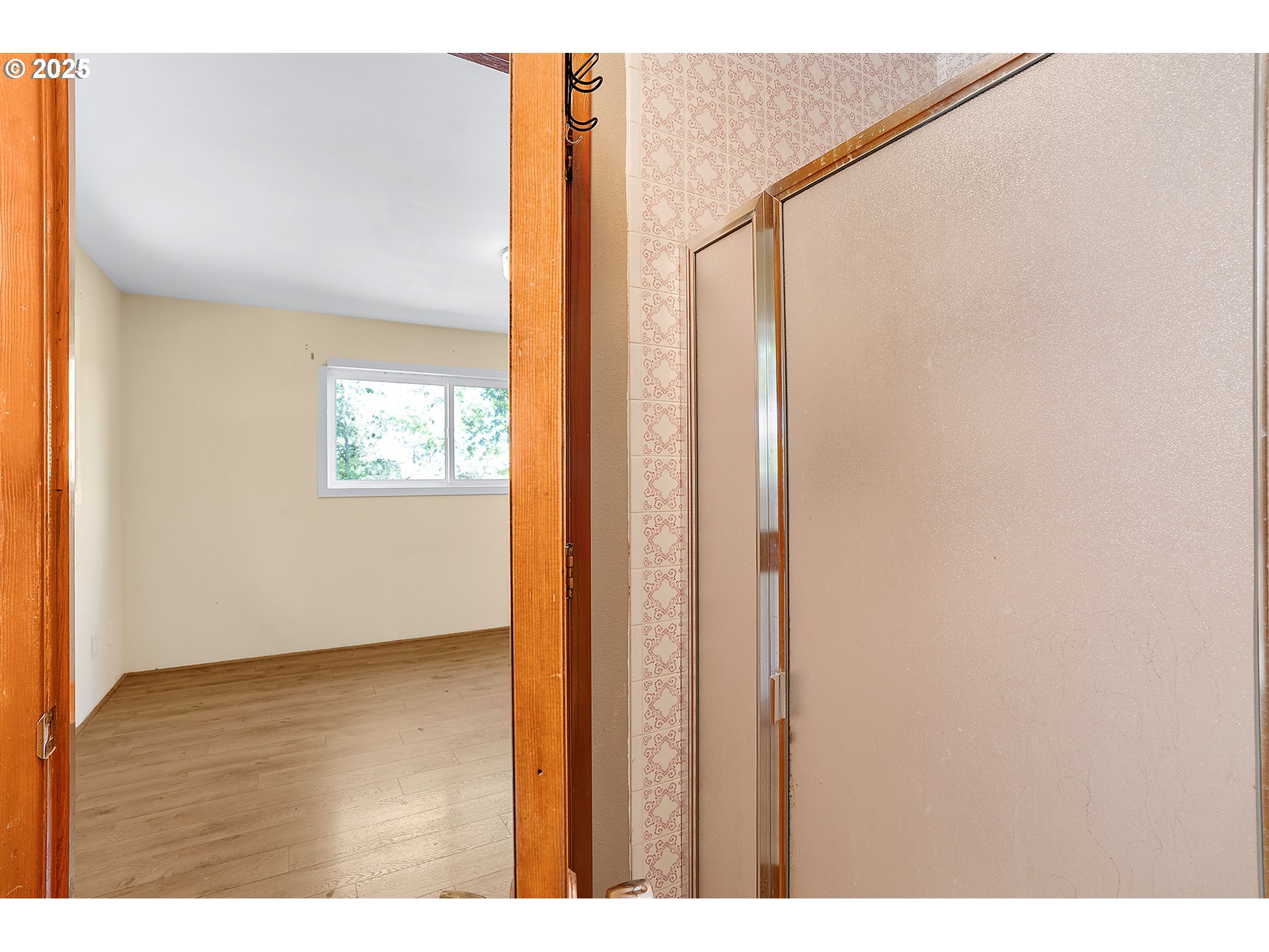 701 Northeast Evans Road Corbett, OR 97019 - Photo 25 of 48 a view of an empty room with wooden floor and a window