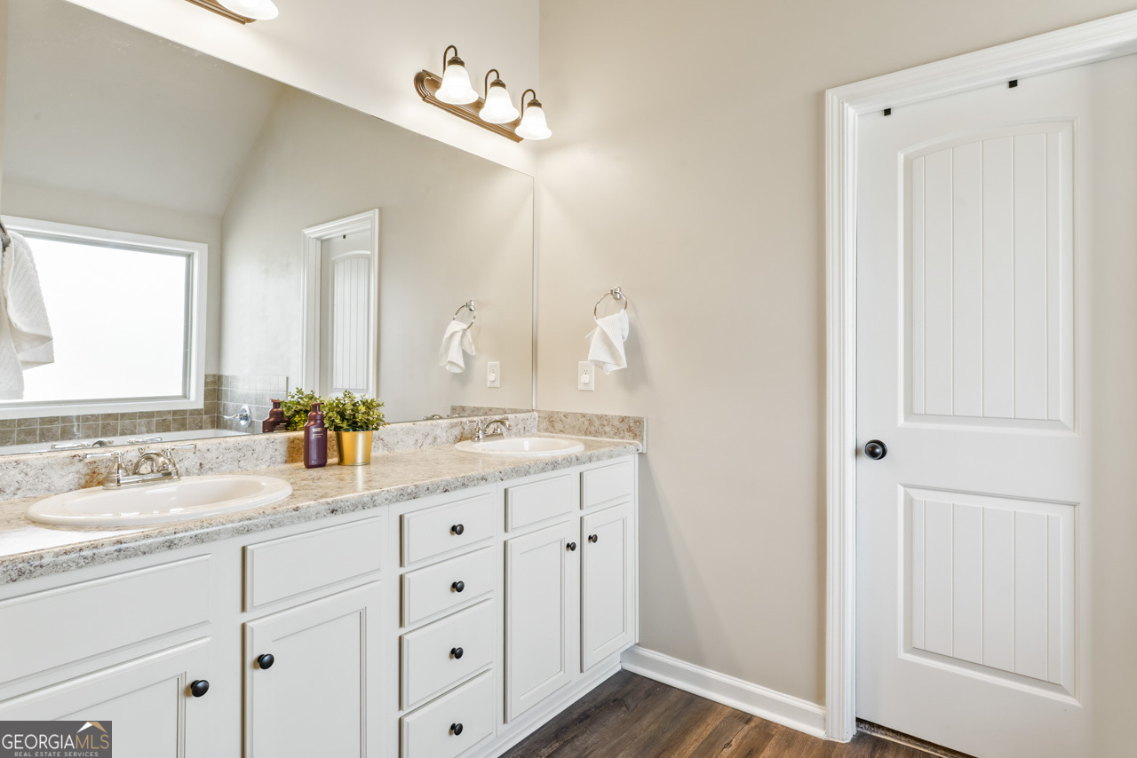 643 Patillo Road Stockbridge, GA 30281 - Photo 21 of 30 a bathroom with a granite countertop sink mirror and double