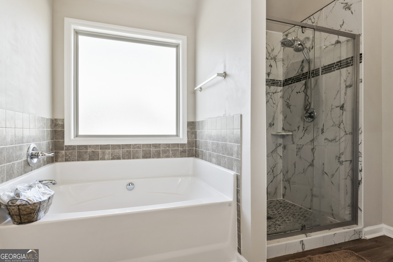 643 Patillo Road Stockbridge, GA 30281 - Photo 22 of 30 a bathroom with a shower and a bathtub