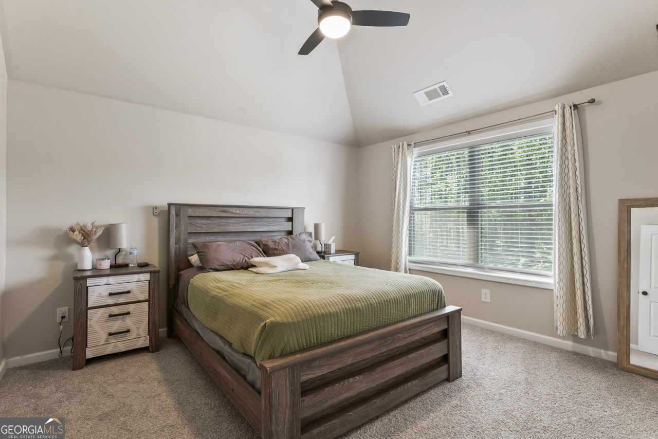 643 Patillo Road Stockbridge, GA 30281 - Photo 23 of 30 a bedroom with a bed and a window