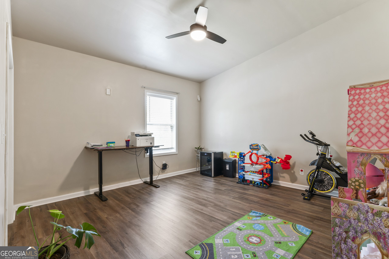 643 Patillo Road Stockbridge, GA 30281 - Photo 26 of 30 a living room with furniture and a wooden floor