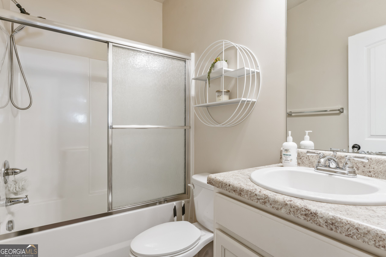 643 Patillo Road Stockbridge, GA 30281 - Photo 27 of 30 a bathroom with a granite countertop sink toilet and a mirror
