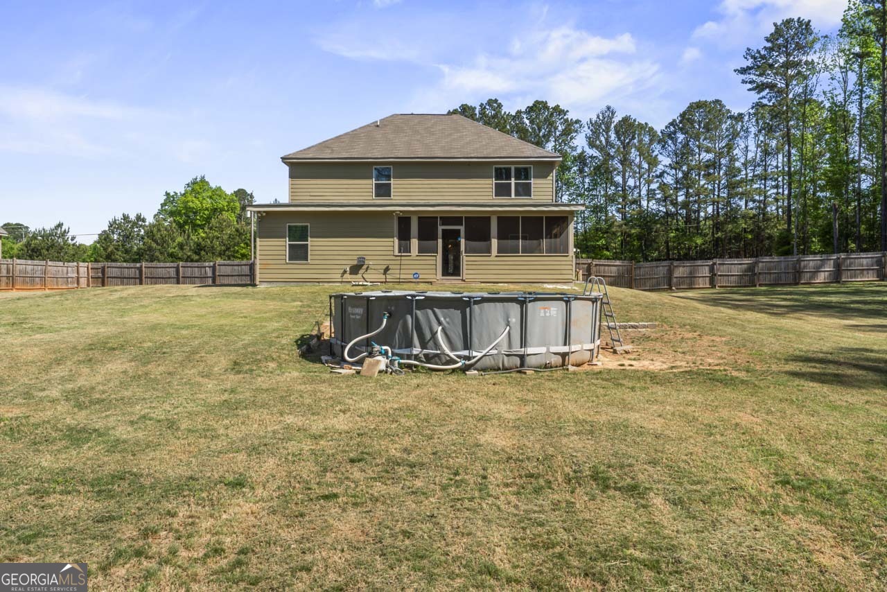 643 Patillo Road Stockbridge, GA 30281 - Photo 29 of 30 a view of a house with a swimming pool and a yard
