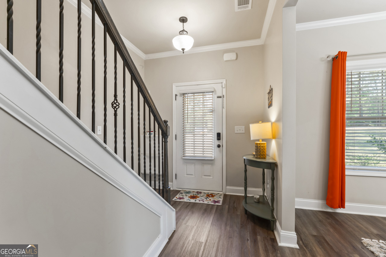 643 Patillo Road Stockbridge, GA 30281 - Photo 6 of 30 a view of hallway with wooden floor and chandelier