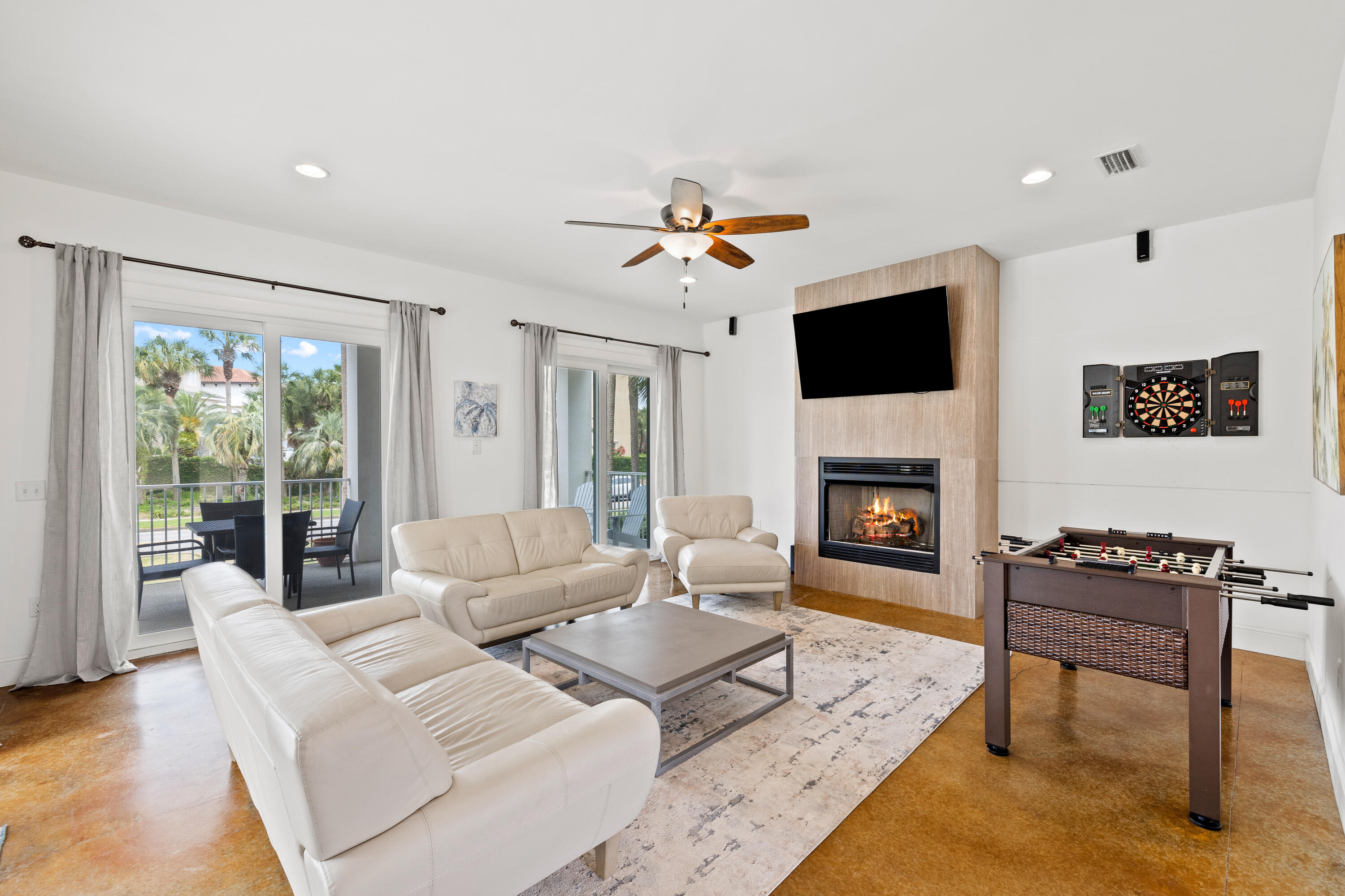 8 St Barts Bay Destin, FL 32541 - Photo 6 of 59 a living room with furniture a flat screen tv and a fireplace