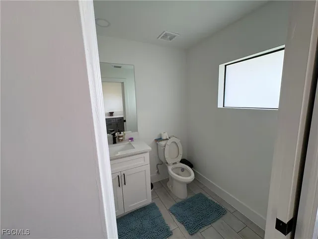 a bathroom with a sink a mirror and vanity