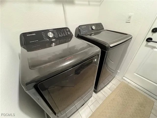 a kitchen with stainless steel appliances granite countertop a sink refrigerator stove and microwave