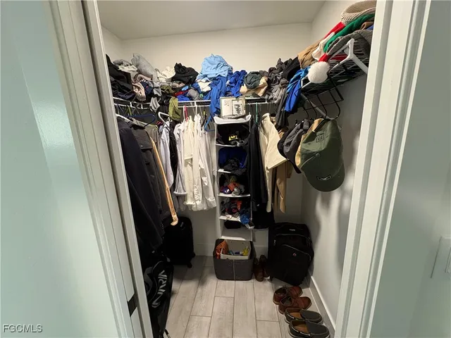 a bedroom with a large bed and a flat screen tv