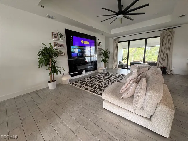 a work room with furniture and a floor to ceiling window