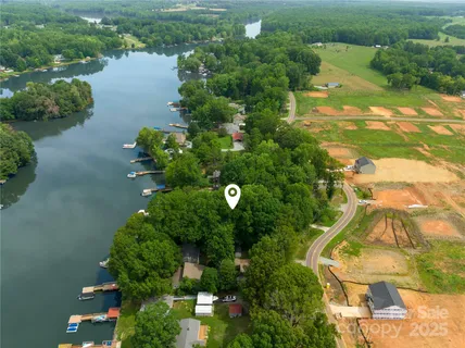 an aerial view of lake residential house and space with swimming pool