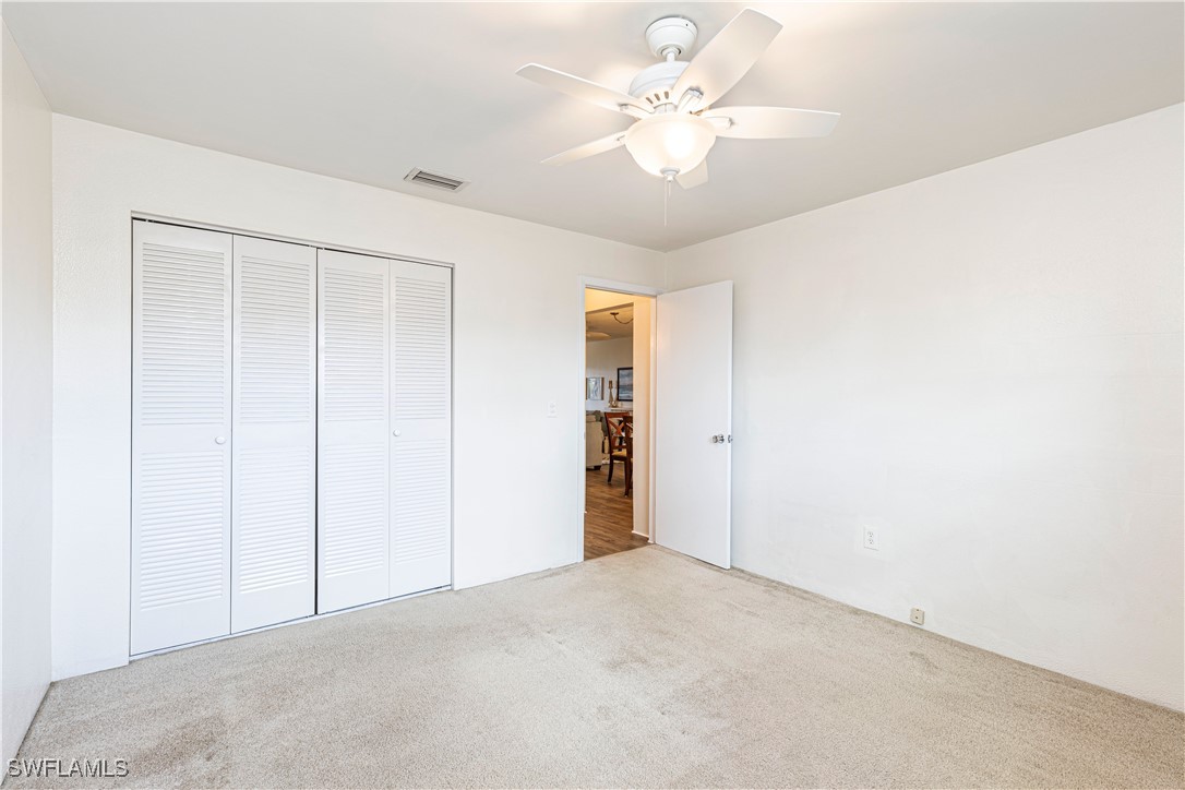 7043 New Post Road, Unit 7 North Fort Myers, FL 33917 - Photo 19 of 26 an empty room with a ceiling fan