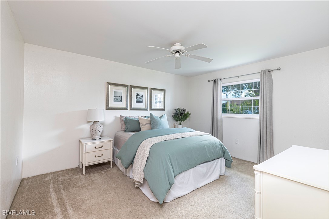 7043 New Post Road, Unit 7 North Fort Myers, FL 33917 - Photo 20 of 26 a spacious bedroom with a bed and a window