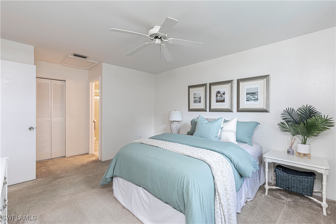 7043 New Post Road, Unit 7 North Fort Myers, FL 33917 - Photo 21 of 26 a bedroom with a large bed and a chandelier