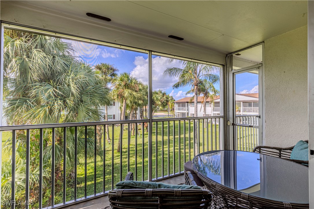 7043 New Post Road, Unit 7 North Fort Myers, FL 33917 - Photo 23 of 26 a view of a balcony with chair and wooden floor