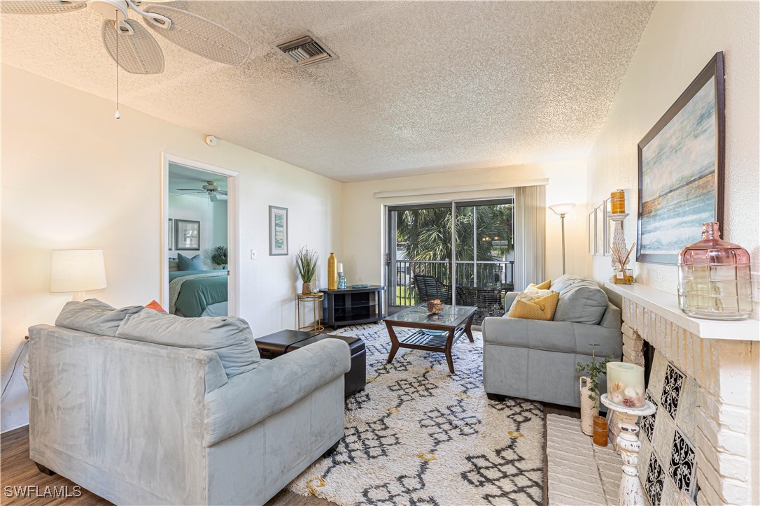 7043 New Post Road, Unit 7 North Fort Myers, FL 33917 - Photo 10 of 26 a living room with furniture and a large window