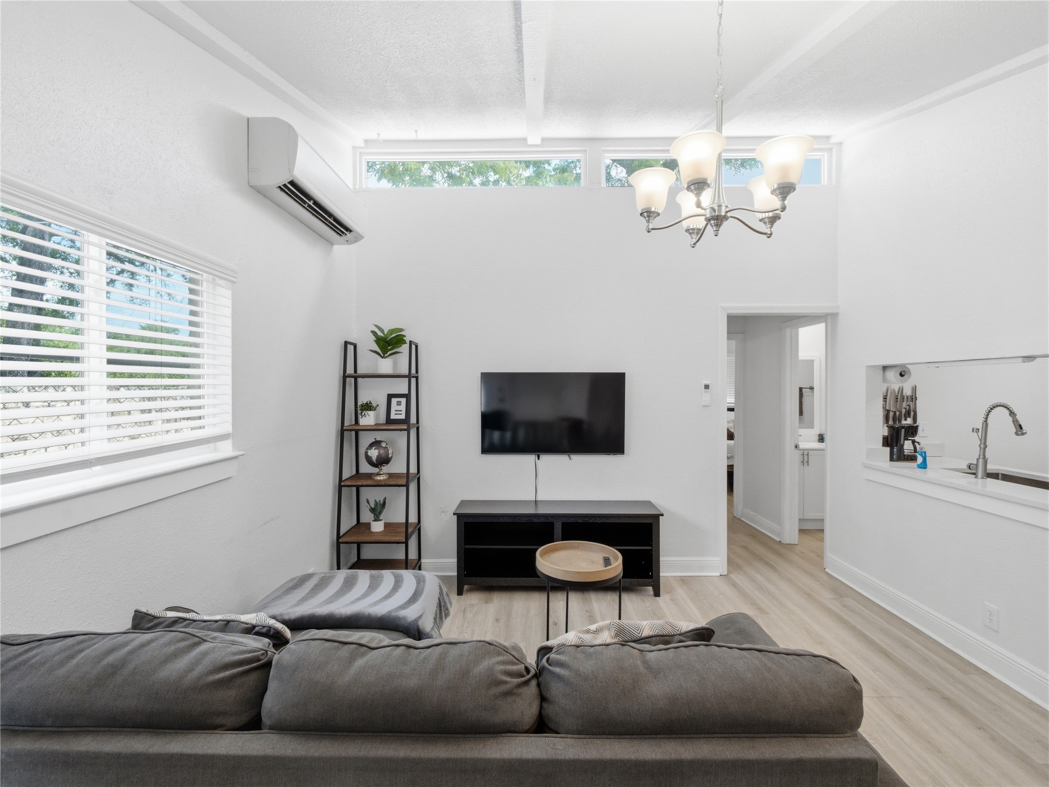 1108 Jolena Circle Austin, TX 78721 - Photo 2 of 21 A living space offers a striking vaulted ceiling and light-hued flooring.