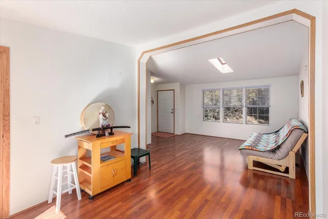 a view of living room filled with furniture and wooden floor