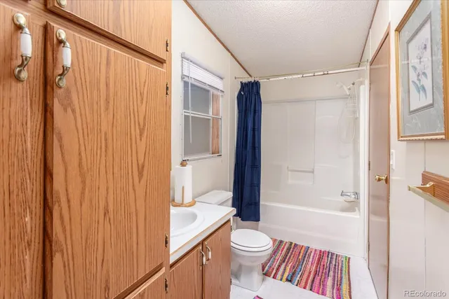 a bathroom with a shower curtain and a sink