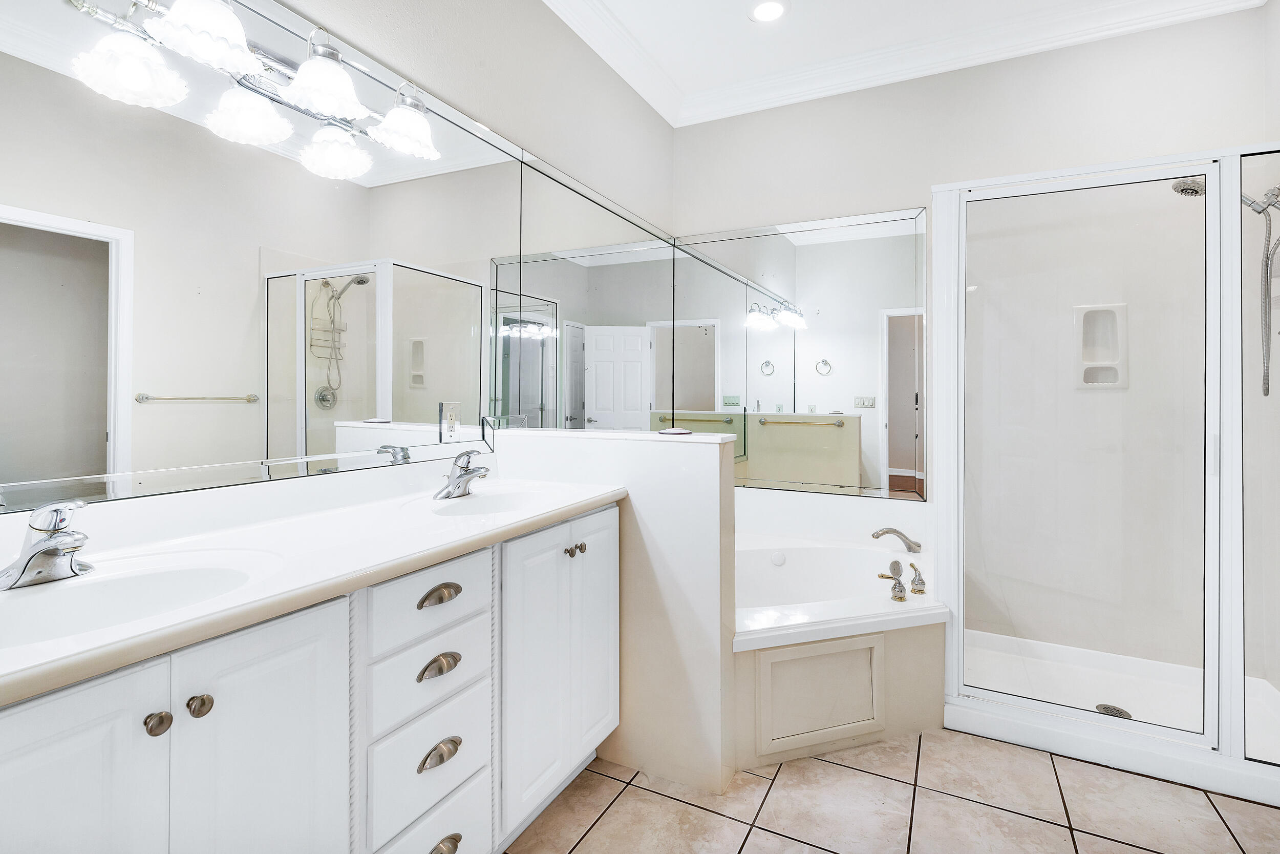 389 Churchill Bayou Road Santa Rosa Beach, FL 32459 - Photo 15 of 38 a spacious bathroom with a double vanity sink mirror and bathtub