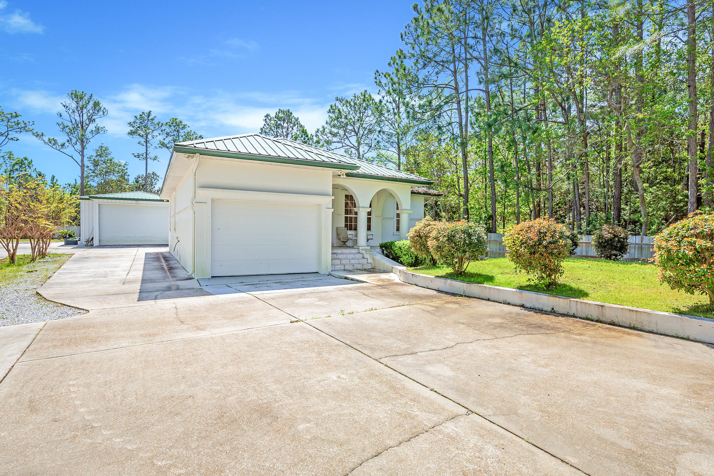 389 Churchill Bayou Road Santa Rosa Beach, FL 32459 - Photo 4 of 38 a view of a house with a yard and a garage