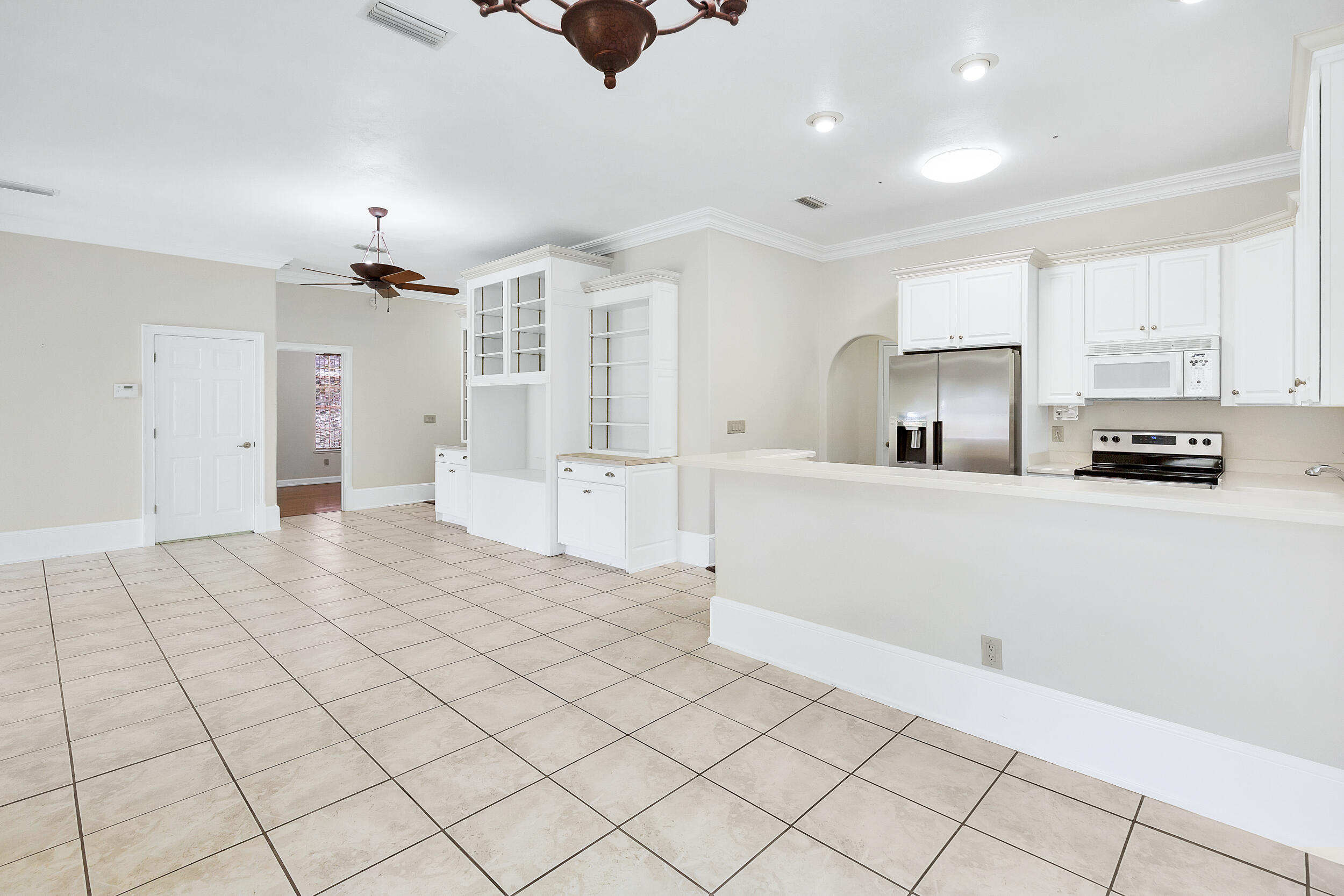 389 Churchill Bayou Road Santa Rosa Beach, FL 32459 - Photo 5 of 38 a large white kitchen with cabinets