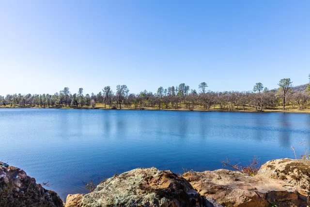 an aerial view of house with yard and mountain in the background