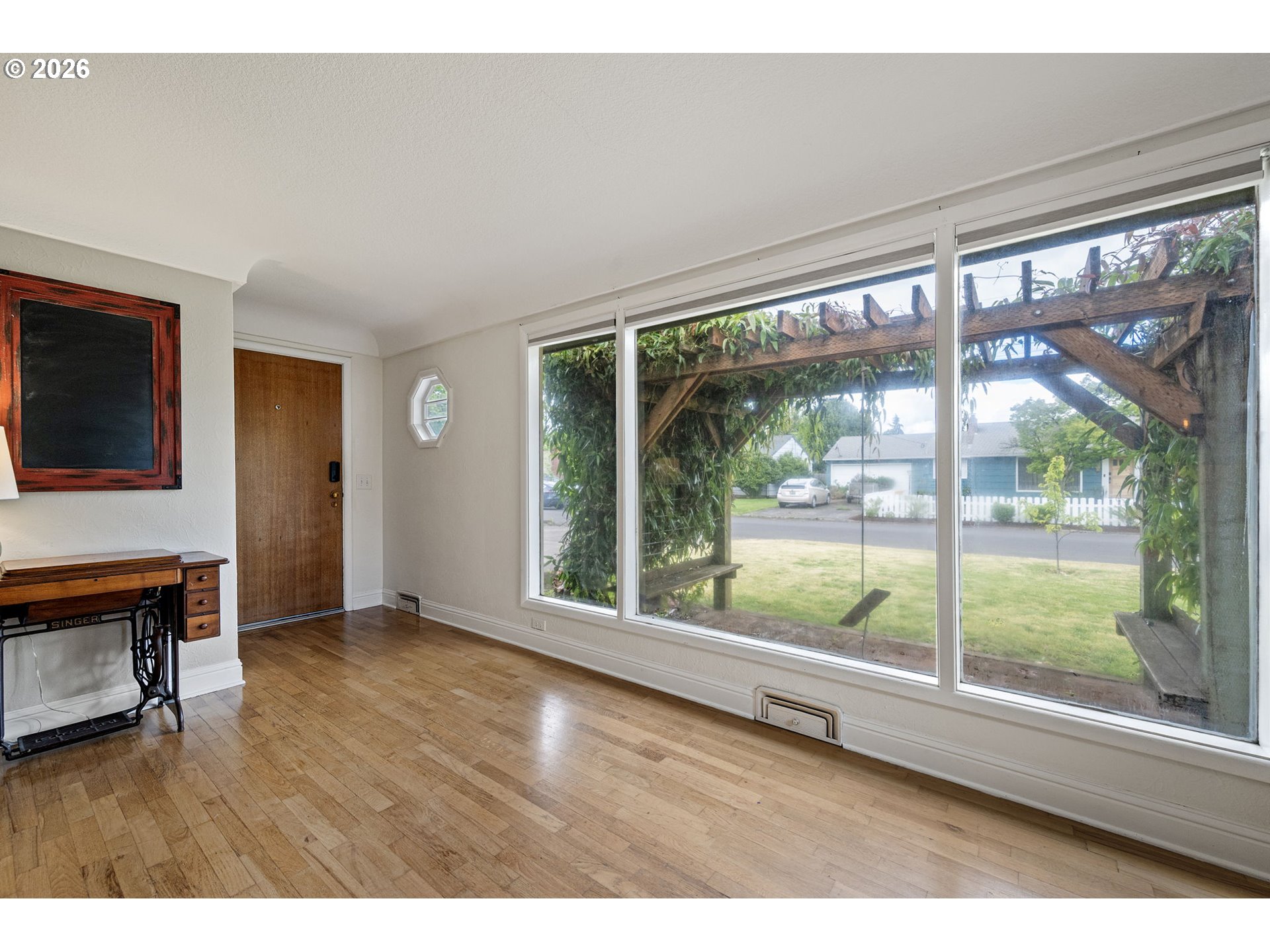 765 Louis Street Eugene, OR 97402 - Photo 4 of 45 a view of an empty room with wooden floor and a window