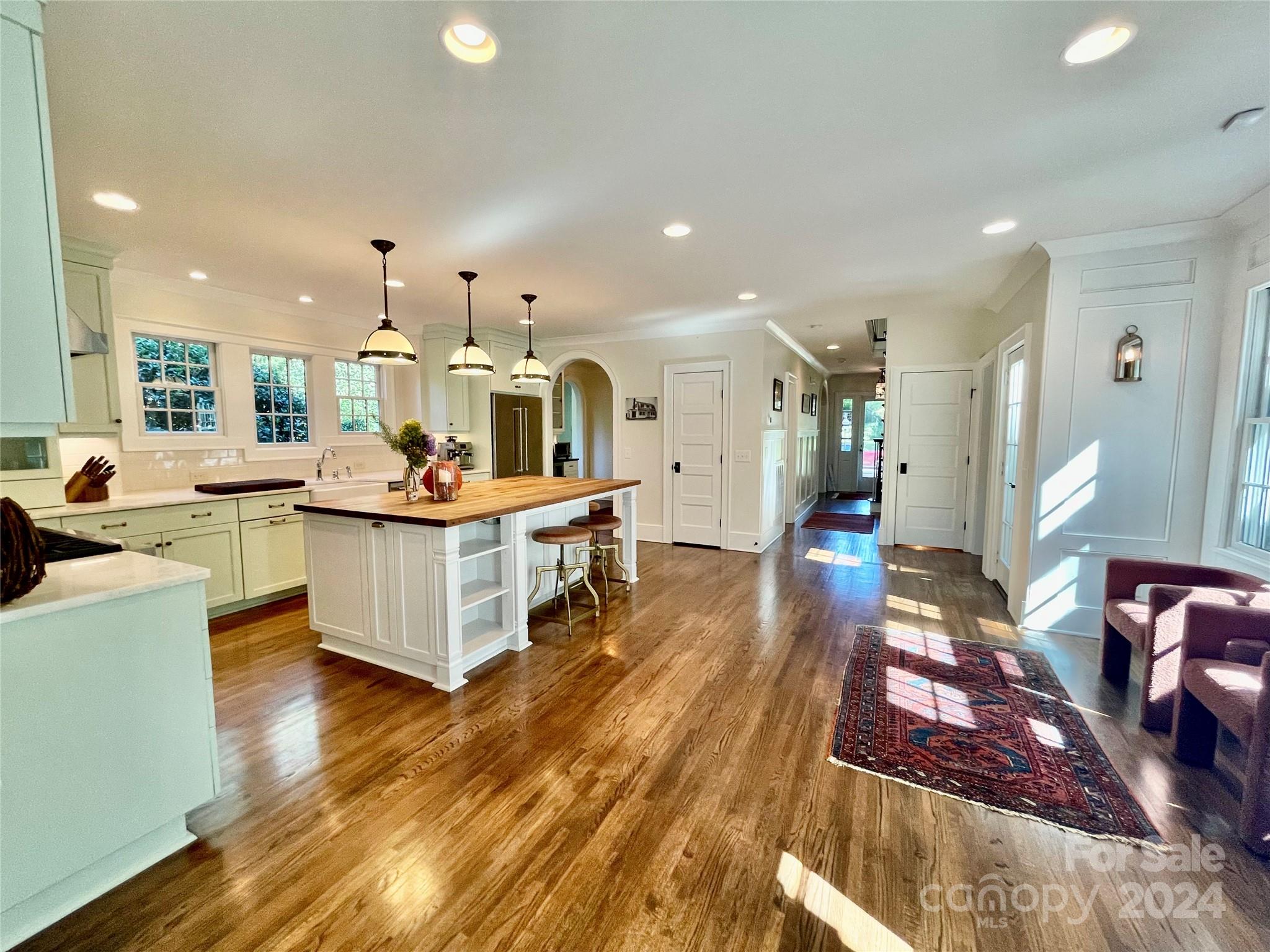 526 Lorimer Road Davidson, NC 28036 - Photo 14 of 41 a living room with kitchen island furniture and a wooden floor