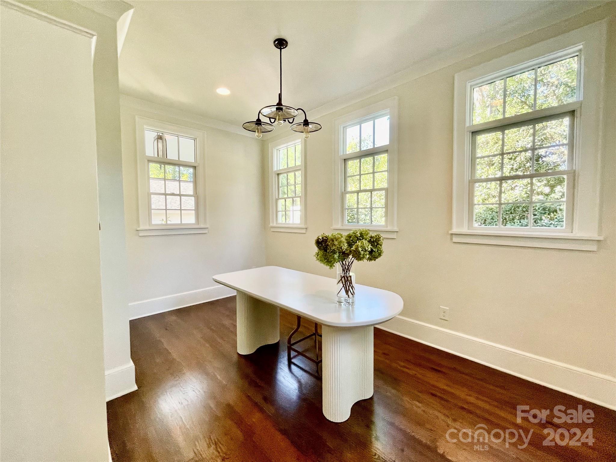 526 Lorimer Road Davidson, NC 28036 - Photo 19 of 41 a view of a dining room with furniture wooden floor and chandelier