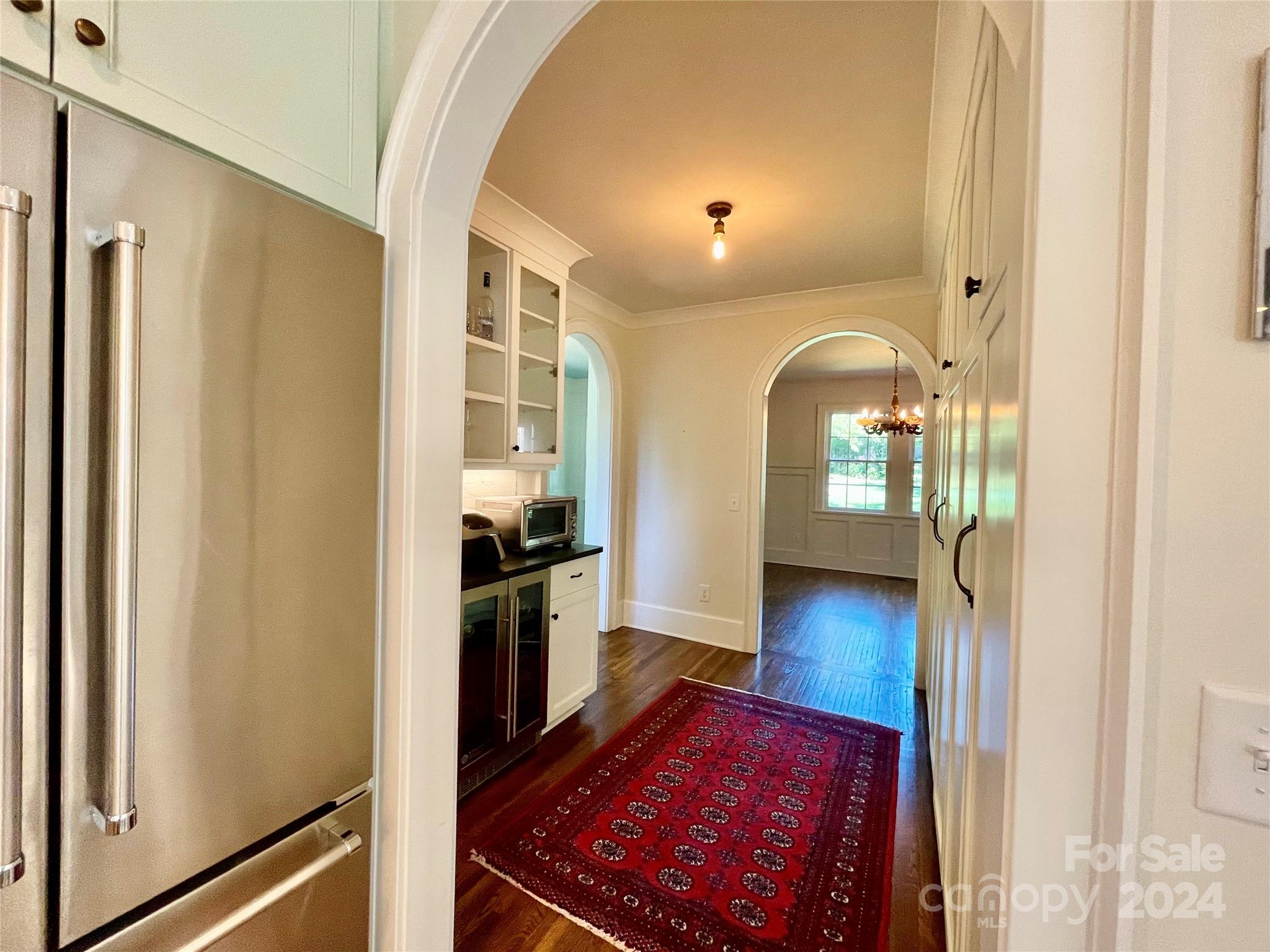 526 Lorimer Road Davidson, NC 28036 - Photo 37 of 41 a view of a hallway with wooden floor and a living room