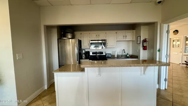 a lobby with furniture and potted plants