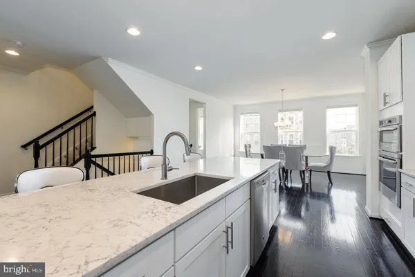 a kitchen with sink and view living room