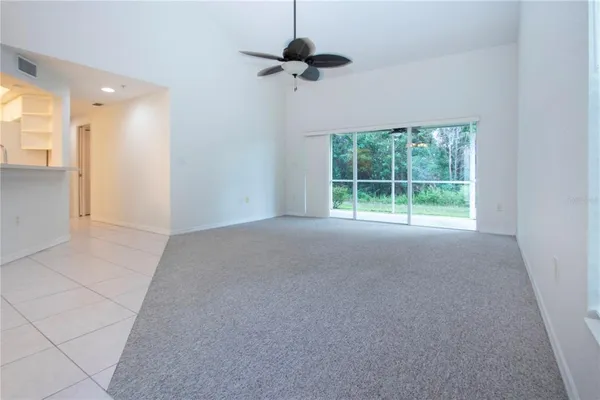 a view of empty room with a ceiling fan and window