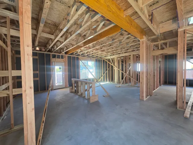 a view of a room with wooden chairs