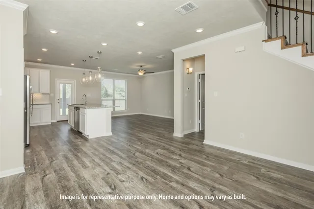 a view of kitchen with kitchen island white cabinets and refrigerator