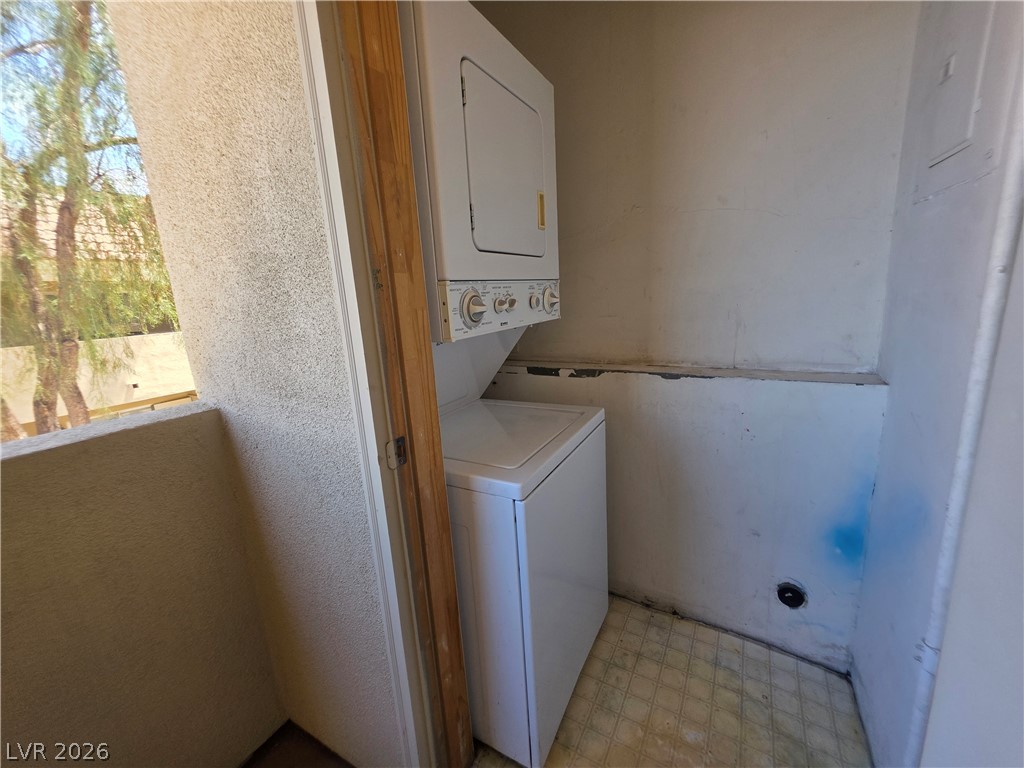 1844 North Decatur Boulevard, Unit 204 Las Vegas, NV 89108 - Photo 20 of 21 An enclosed outdoor laundry closet features a stacked washer and dryer setup next to the balcony.